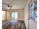 Living room featuring hardwood floors, ceiling fan, and sliding glass door at 3915 W San Pedro St, Tampa, FL 33629