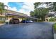 Community parking with covered spaces and well-maintained landscaping at 12300 Vonn Rd # 9105, Largo, FL 33774