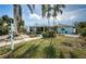 Large backyard with tropical landscaping and canal view at 14035 E Parsley Dr, Madeira Beach, FL 33708