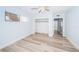 Well-lit bedroom with wood-look floors and a large closet at 14035 E Parsley Dr, Madeira Beach, FL 33708