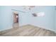 Bright bedroom featuring wood-look floors and access to bathroom at 14035 E Parsley Dr, Madeira Beach, FL 33708