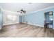 Spacious living room featuring wood-look floors and a ceiling fan at 14035 E Parsley Dr, Madeira Beach, FL 33708