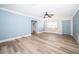 Light-filled living room with wood-look floors and an accent wall at 14035 E Parsley Dr, Madeira Beach, FL 33708