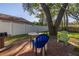 Backyard patio with table, chairs, and large tree at 2227 Willowbrook Dr, Clearwater, FL 33764