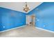 Blue dining room with chandelier and view of hallway at 2227 Willowbrook Dr, Clearwater, FL 33764