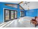 Sunroom with blue walls, wood features, and access to backyard at 2227 Willowbrook Dr, Clearwater, FL 33764