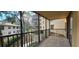 Screened balcony overlooking lush landscaping and trees at 3076 Eastland Blvd # 106, Clearwater, FL 33761