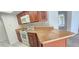 Kitchen with breakfast bar and wood cabinets at 3076 Eastland Blvd # 106, Clearwater, FL 33761