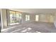 Sunlit living room with sliding doors leading to a balcony at 3076 Eastland Blvd # 106, Clearwater, FL 33761