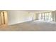 Open living room with neutral color palette and access to balcony at 3076 Eastland Blvd # 106, Clearwater, FL 33761