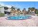 Relaxing community pool with patio and surrounding buildings at 2424 W Tampa Bay Blvd # D203, Tampa, FL 33607