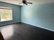 Bedroom with dark hardwood floors and a window at 3336 Bellericay Ln, Land O Lakes, FL 34638