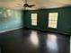 Large bedroom with dark hardwood floors and two windows at 3336 Bellericay Ln, Land O Lakes, FL 34638