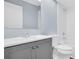 Bathroom with gray vanity and wood-look flooring at 3499 Cedar Ln, Palm Harbor, FL 34684