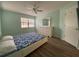 Bedroom with wood floors, ceiling fan, and dresser at 3499 Cedar Ln, Palm Harbor, FL 34684