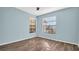 Bright bedroom with wood-look flooring and window coverings at 3499 Cedar Ln, Palm Harbor, FL 34684