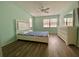 Bedroom with wood floors, ceiling fan, and dresser at 3499 Cedar Ln, Palm Harbor, FL 34684