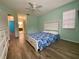 Bedroom with wood floors and access to bathroom at 3499 Cedar Ln, Palm Harbor, FL 34684