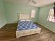 Bedroom with wood floors and ceiling fan at 3499 Cedar Ln, Palm Harbor, FL 34684