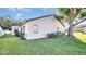 White house exterior with a well-manicured lawn and mature trees at 3499 Cedar Ln, Palm Harbor, FL 34684