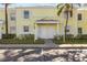 Bright yellow duplex with two entrances, landscaping, and parking at 5026 Coquina Key Se Dr # 5026, St Petersburg, FL 33705