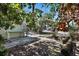 Backyard patio area with a work bench and tropical landscaping at 7060 Boca Ciega Dr, St Pete Beach, FL 33706