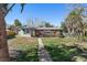 Ranch style home with light green exterior and palm trees at 7060 Boca Ciega Dr, St Pete Beach, FL 33706