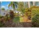 Landscaped backyard with tropical plants and grass at 790 7Th Ne Ave, Largo, FL 33770