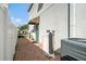 Brick paved walkway leads to the back of the house, showing AC unit and water softener at 790 7Th Ne Ave, Largo, FL 33770