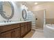 Elegant bathroom with double vanity, soaking tub, and shower at 790 7Th Ne Ave, Largo, FL 33770