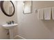 Simple bathroom with pedestal sink and decorative mirror at 790 7Th Ne Ave, Largo, FL 33770