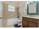 Clean bathroom with shower/tub combo, vanity, and mosaic mirror at 790 7Th Ne Ave, Largo, FL 33770