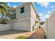 Home's exterior showcasing a large garage and a brick paved pathway at 790 7Th Ne Ave, Largo, FL 33770