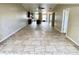 Open concept living room with tile floors and views into kitchen area at 7907 Radcliffe Cir # 7907, Port Richey, FL 34668