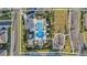 An aerial view of a community pool, playground, parking, and green space at 19157 Elsimont Isle, Lutz, FL 33558