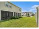 The manicured lawn is adjacent to the screened-in patio of this townhome at 19157 Elsimont Isle, Lutz, FL 33558