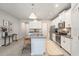 Well-lit kitchen with stainless steel appliances, white cabinetry, granite countertops, and bar seating at 19157 Elsimont Isle, Lutz, FL 33558