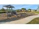 Community playground featuring a slide, swings, and climbing structure for outdoor fun at 19157 Elsimont Isle, Lutz, FL 33558