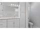 Bathroom with white cabinets and marble-look vanity at 7214 Blossom Ave, Tampa, FL 33614