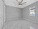 Spacious bedroom with ceiling fan and window at 7214 Blossom Ave, Tampa, FL 33614