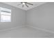 Spacious bedroom with ceiling fan and large window, featuring marble flooring at 7214 N Blossom Ave, Tampa, FL 33614