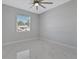 Bright bedroom with ceiling fan and window at 7214 Blossom Ave, Tampa, FL 33614