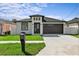 Single-story home with dark brown garage door and mailbox at 7214 Blossom Ave, Tampa, FL 33614