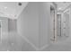 Light and bright hallway with marble flooring and access to other rooms at 7214 N Blossom Ave, Tampa, FL 33614