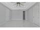 Main bedroom with ceiling fan, and walk-in closet, featuring marble flooring at 7214 N Blossom Ave, Tampa, FL 33614