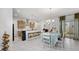 Bright dining area with white table and chairs next to the kitchen at 8441 Ivy Stark Blvd, Wesley Chapel, FL 33545