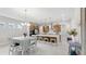 Kitchen and dining area with white table and chairs, and view of kitchen at 8441 Ivy Stark Blvd, Wesley Chapel, FL 33545