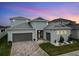 Two-story house with gray exterior and pavers at 8441 Ivy Stark Blvd, Wesley Chapel, FL 33545