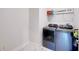 Bright laundry room with washer, dryer, and storage at 8441 Ivy Stark Blvd, Wesley Chapel, FL 33545