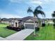 One-story house with a gray exterior, landscaping, and a palm tree next to it at 11101 58Th Street E Cir, Parrish, FL 34219
